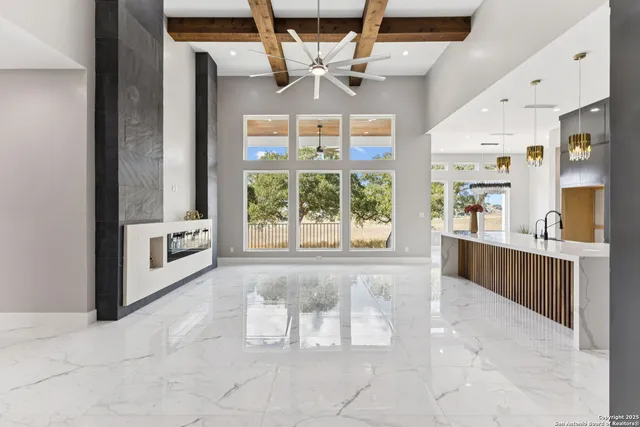 a view of a livingroom with a fireplace and a window