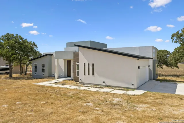 a big house with yard and a large tree