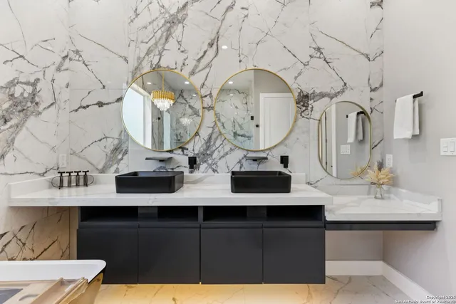 a bathroom with a bathtub and a double vanity sink