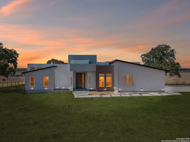 a house with yard and ocean view