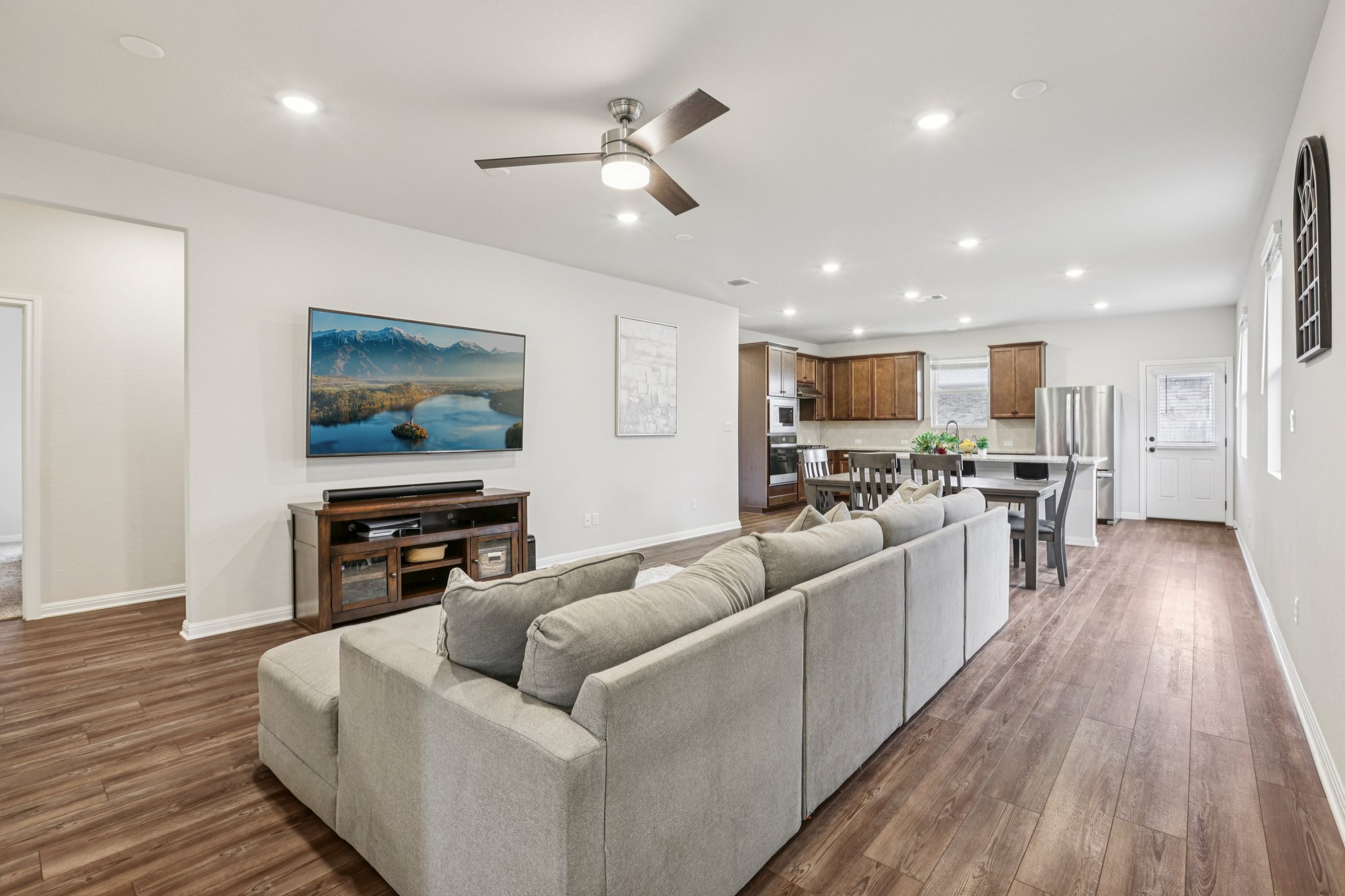 204 Swinging H Lane Georgetown, TX 78633 - Photo 6 of 39 This open concept living space features recessed lighting, a ceiling fan, and rich wood-style flooring