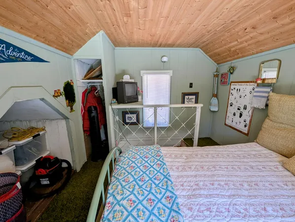 a bed room with a bed and a mirror