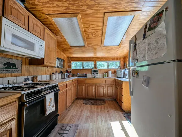 a kitchen with stainless steel appliances granite countertop a stove and a cabinets