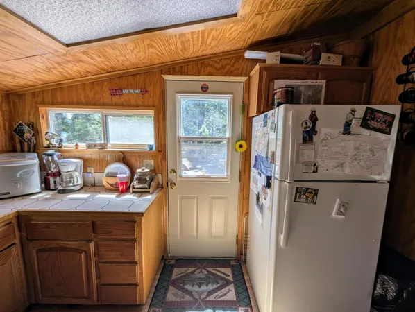 a kitchen with a refrigerator and a sink
