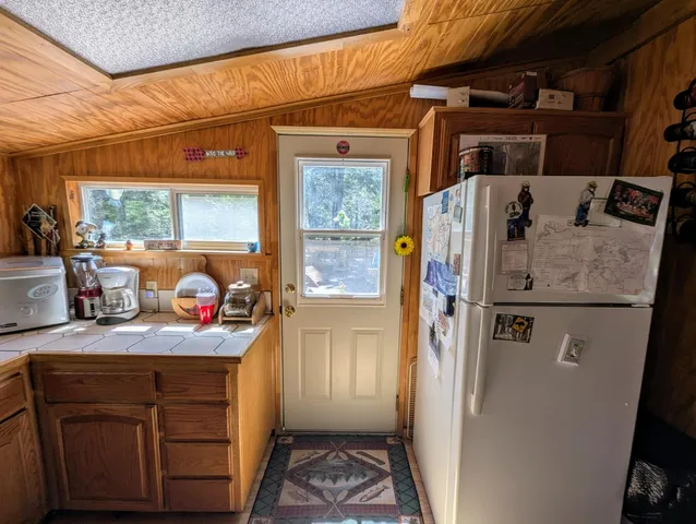 a kitchen with a refrigerator and a sink