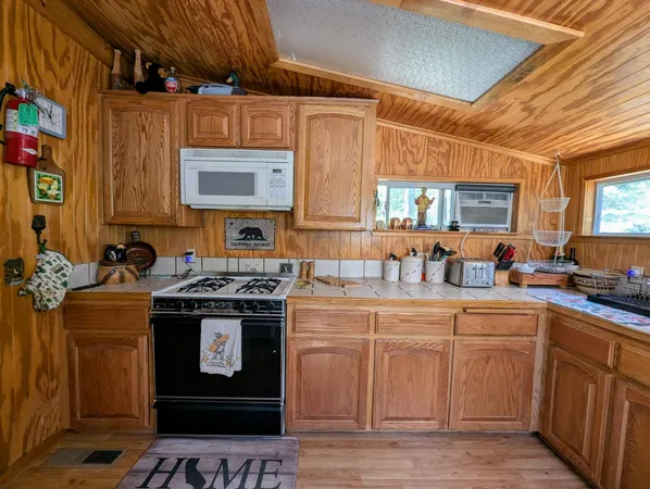 a kitchen with a stove sink and cabinets