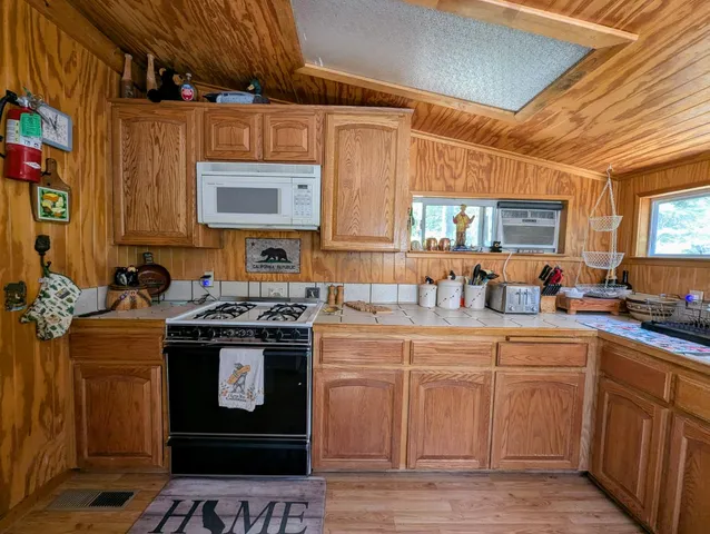 a kitchen with a stove sink and cabinets