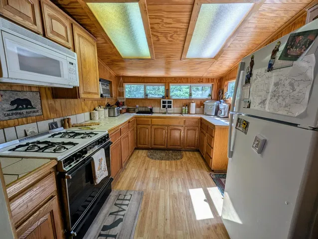 a kitchen with wooden cabinets and a stove top oven