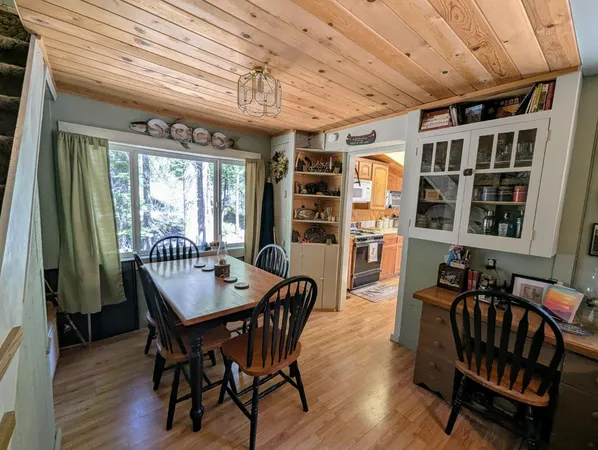 a dining room with furniture window and wooden floor