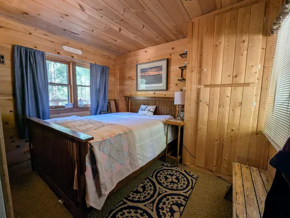 a bed sitting in a bedroom next to a window