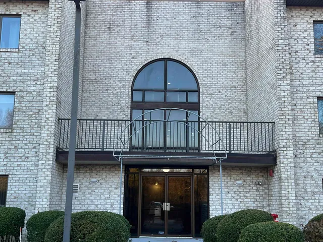 a view of a brick house with a large window