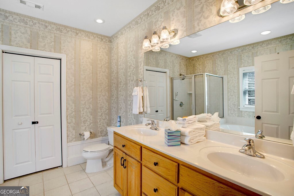 1725 Water Crest Way, Unit D Young Harris, GA 30582 - Photo 18 of 42 a bathroom with a double vanity sink mirror and toilet