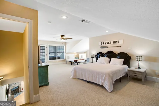 a spacious bedroom with a bed and large windows