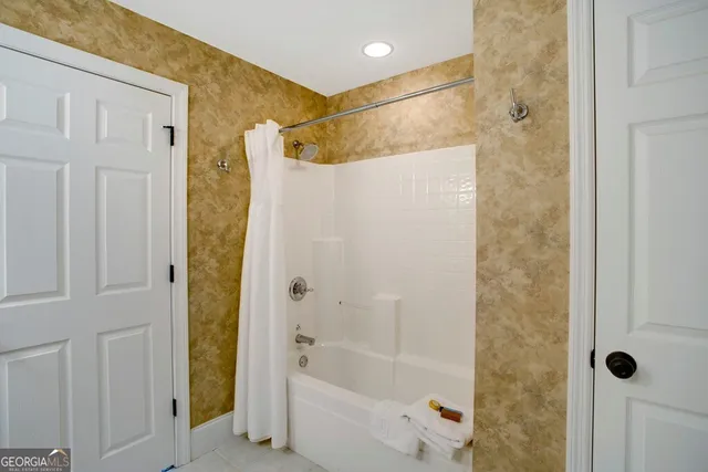 a bathroom with a bathtub and a shower