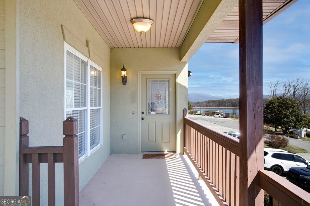 1725 Water Crest Way, Unit D Young Harris, GA 30582 - Photo 28 of 42 a view of a hallway with wooden floor and staircase