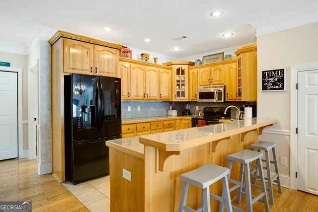 a kitchen with a sink a refrigerator and cabinets