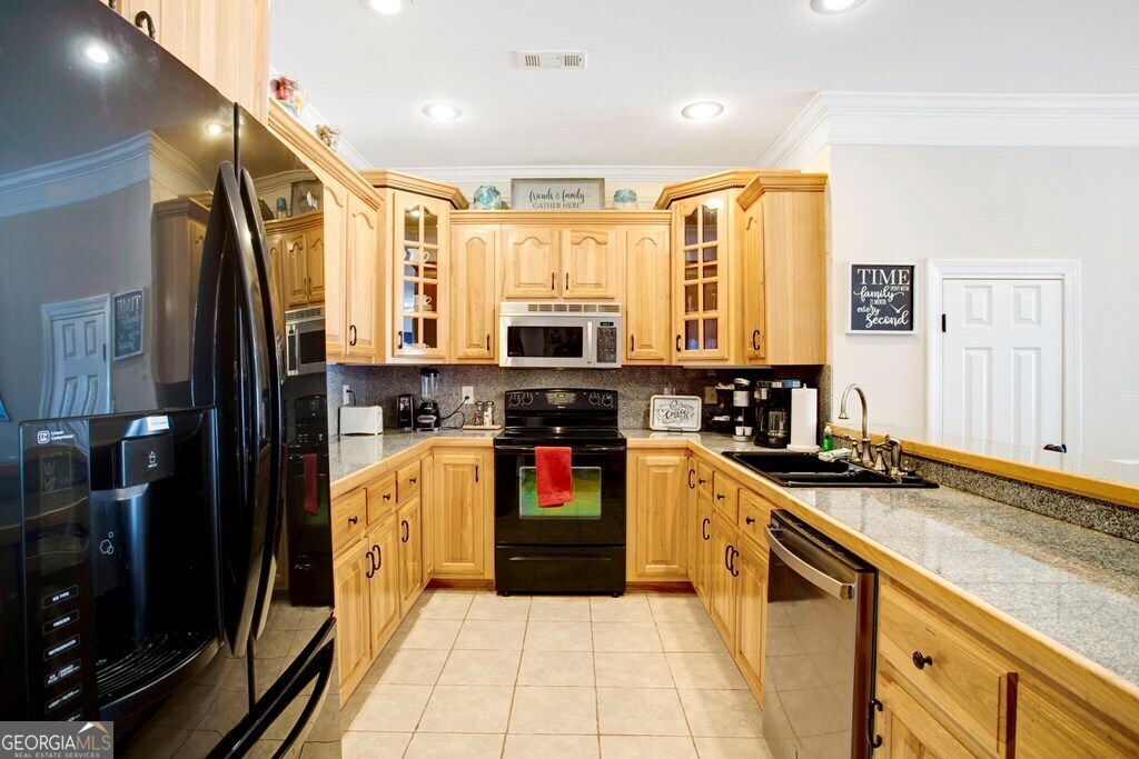 1725 Water Crest Way, Unit D Young Harris, GA 30582 - Photo 9 of 42 a kitchen with stainless steel appliances granite countertop a refrigerator a stove and a sink