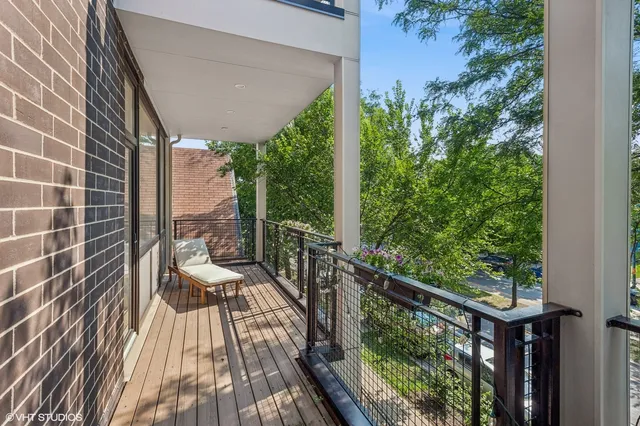 a view of balcony with wooden floor and outdoor seating