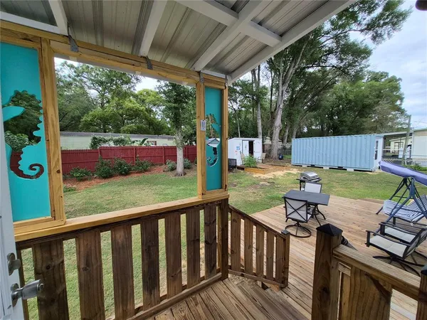 a view of backyard with seating area and green space
