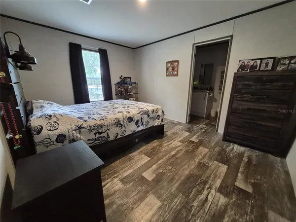 a bedroom with a bed and a dresser
