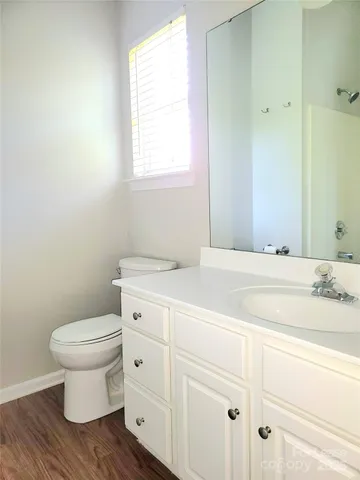 a bathroom with a toilet sink and a window