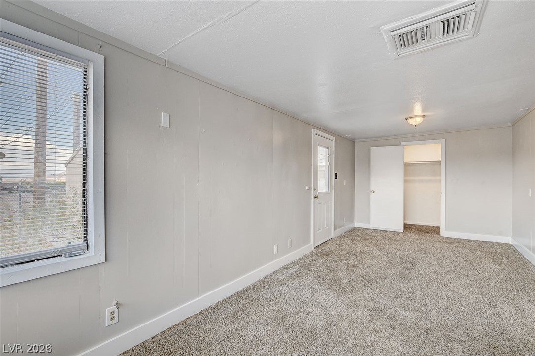 214 West Victory Road Henderson, NV 89015 - Photo 24 of 33 A spacious room offers ample space, complete with soft carpeting and a generous closet.
