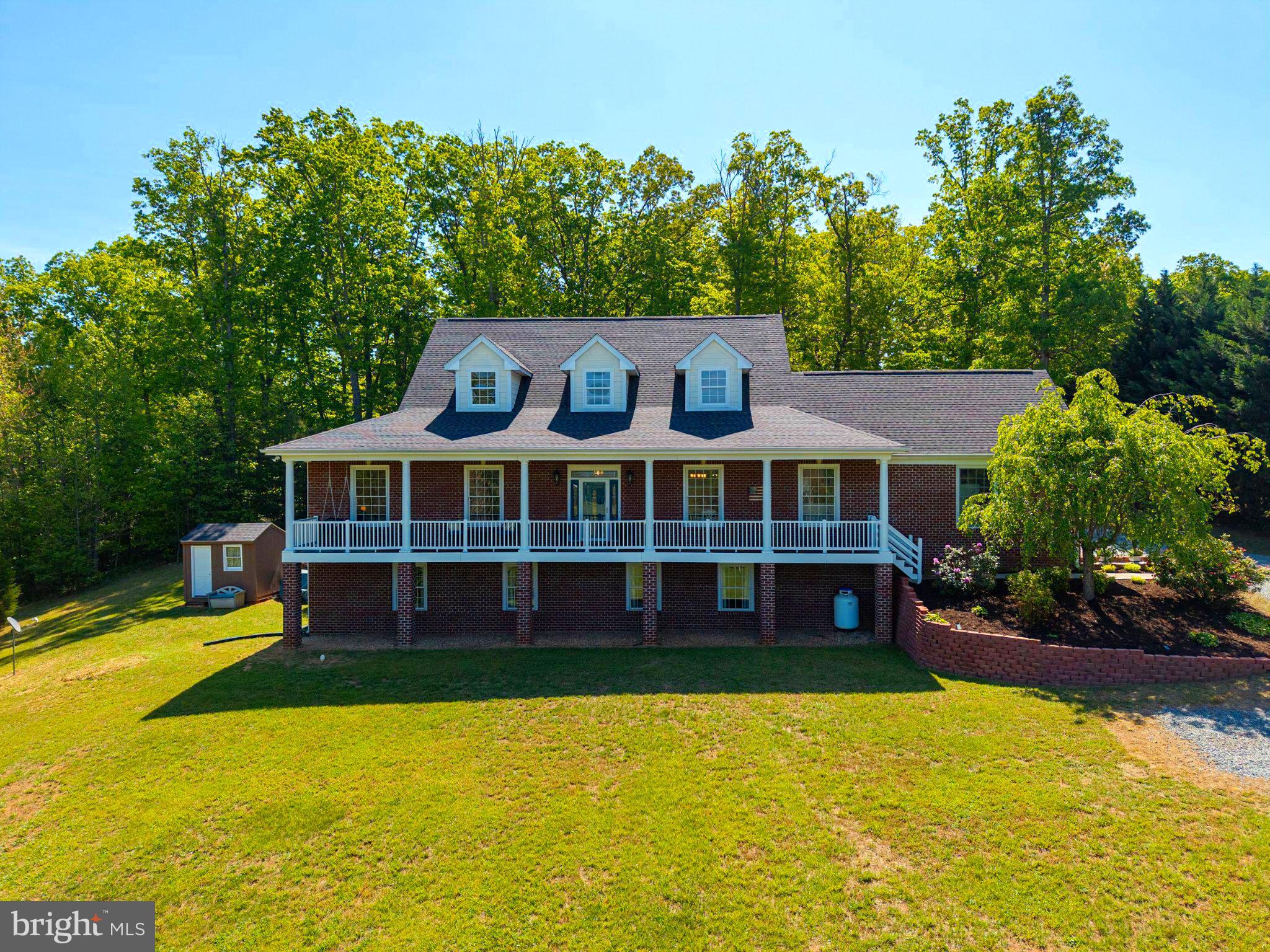 246 Lawsons Farm Circle Ruckersville, VA 22968 - Photo 1 of 130 a front view of a house with a yard table and chairs