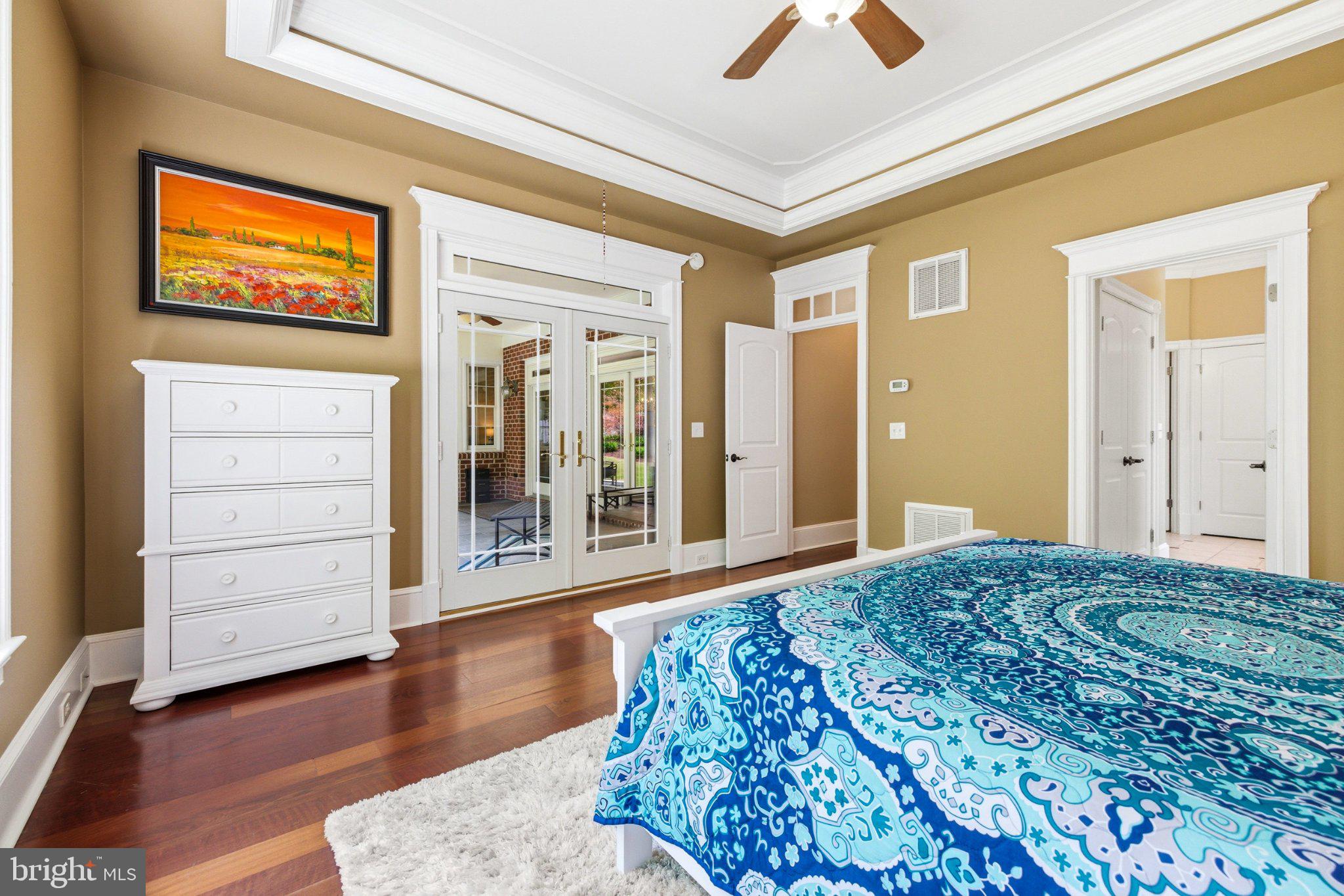 246 Lawsons Farm Circle Ruckersville, VA 22968 - Photo 35 of 130 a bedroom with a bed and a chandelier