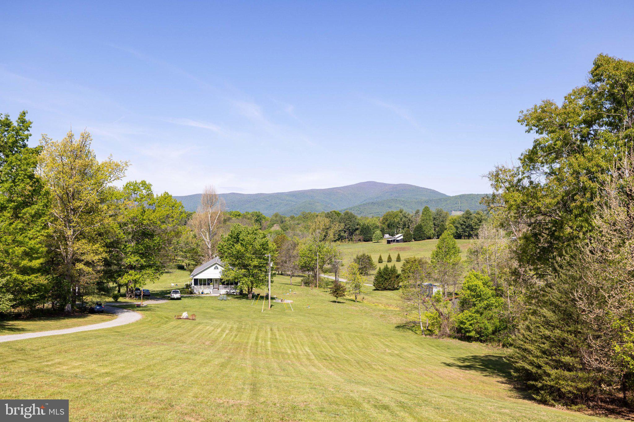 246 Lawsons Farm Circle Ruckersville, VA 22968 - Photo 79 of 130 a view of a lake with a mountain in the background