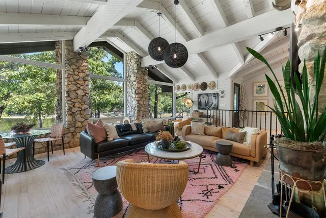 a living room with patio furniture and a large window