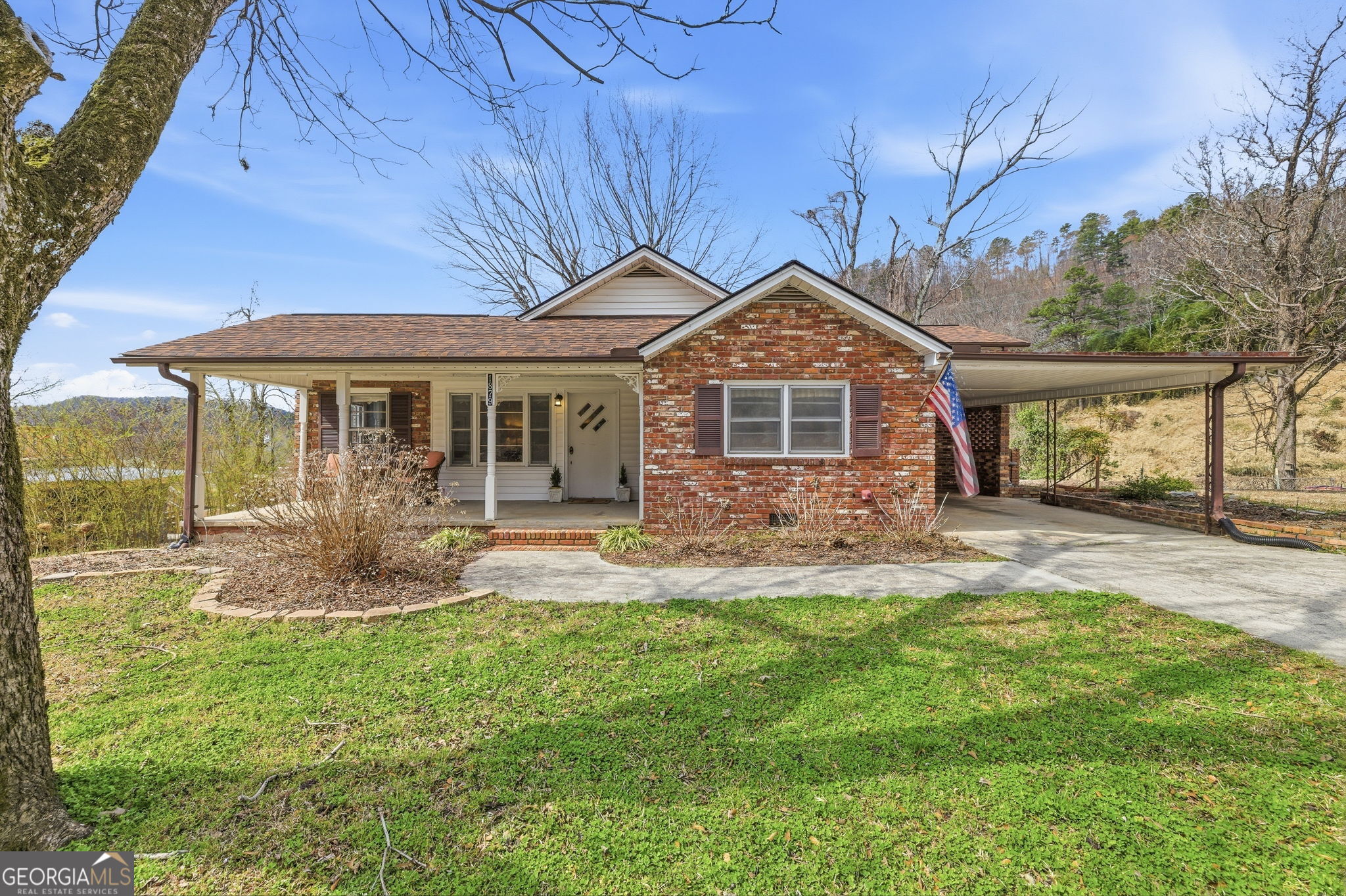 1879 Falls Road Toccoa, GA 30577 - Photo 1 of 36 a front view of a house with a yard table and chairs