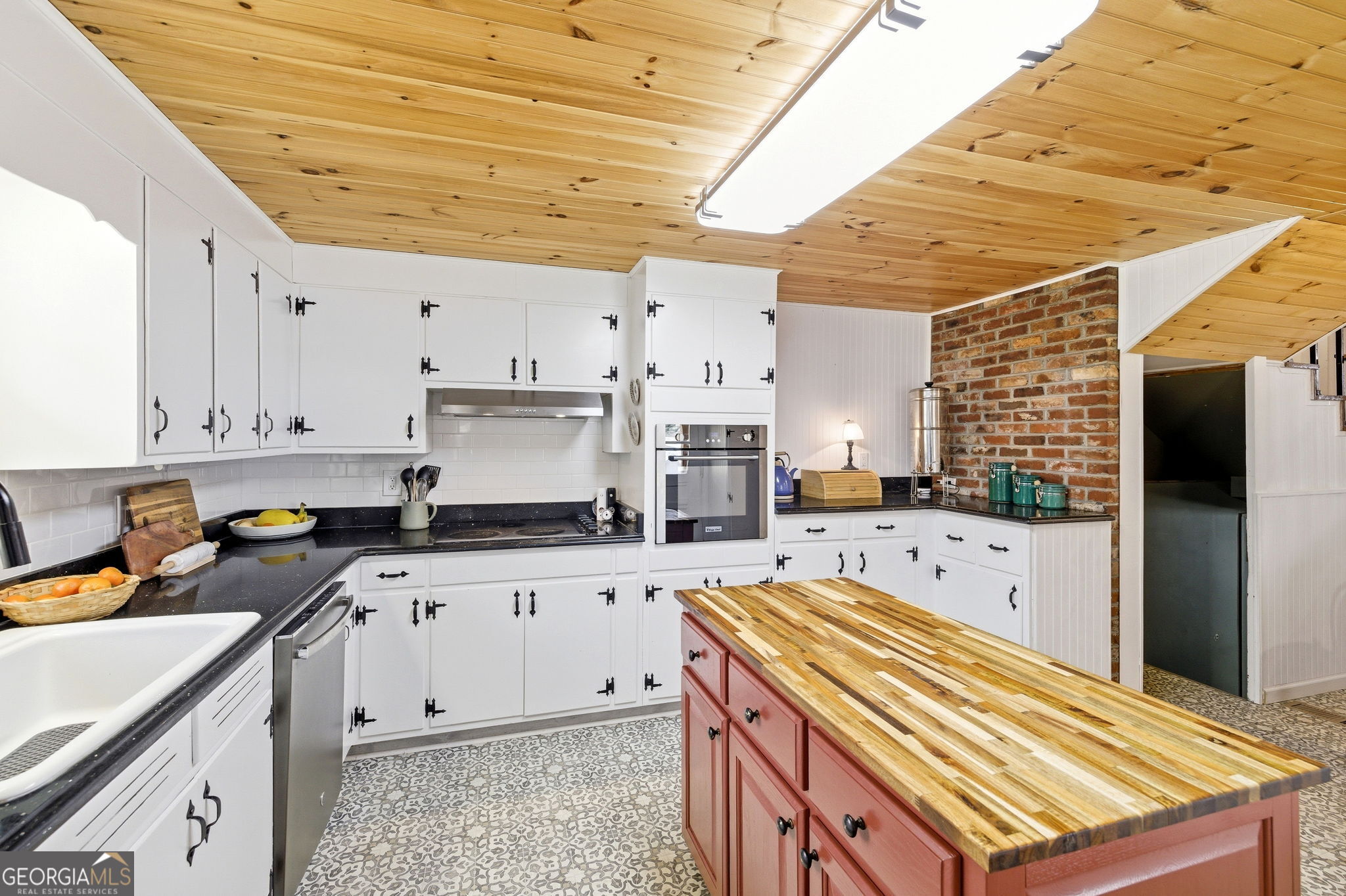 1879 Falls Road Toccoa, GA 30577 - Photo 13 of 36 a kitchen with granite countertop a stove a sink dishwasher and a refrigerator