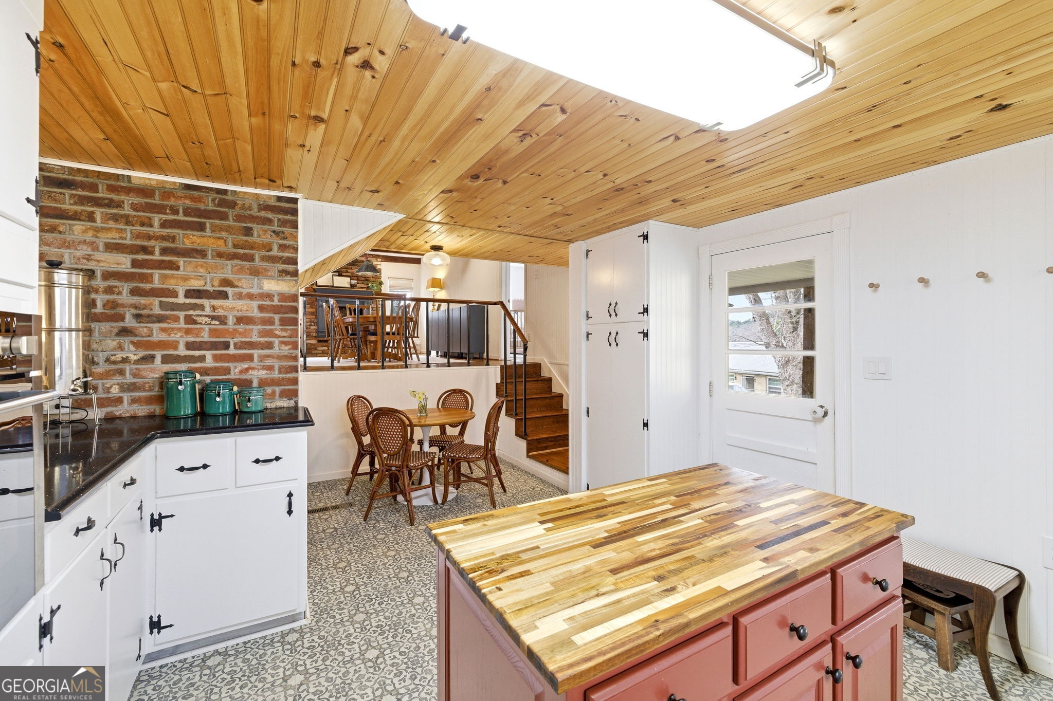 1879 Falls Road Toccoa, GA 30577 - Photo 14 of 36 a living room with stainless steel appliances kitchen island granite countertop furniture and a wooden floor