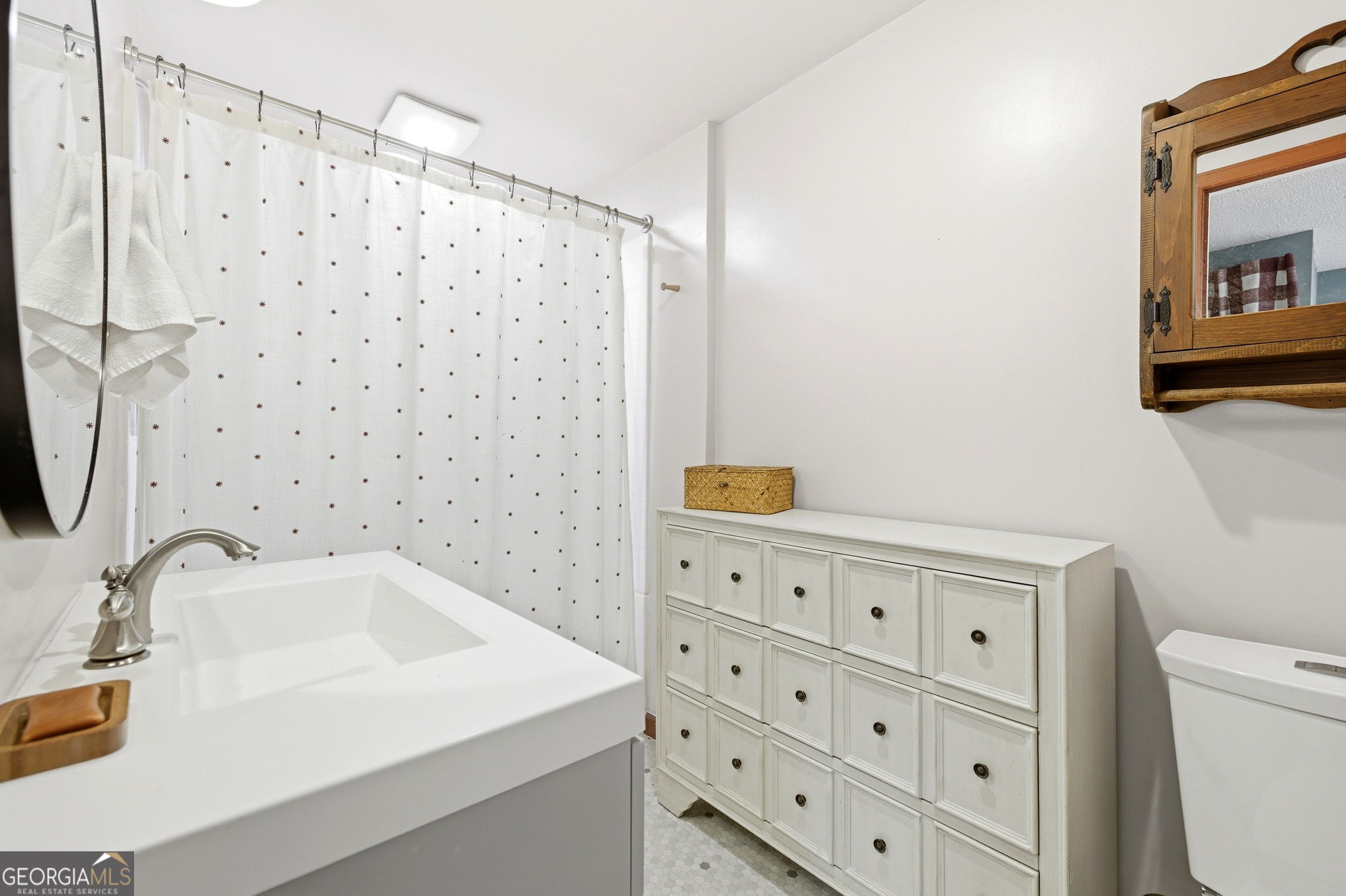 1879 Falls Road Toccoa, GA 30577 - Photo 27 of 36 a bathroom with a sink a toilet and a mirror