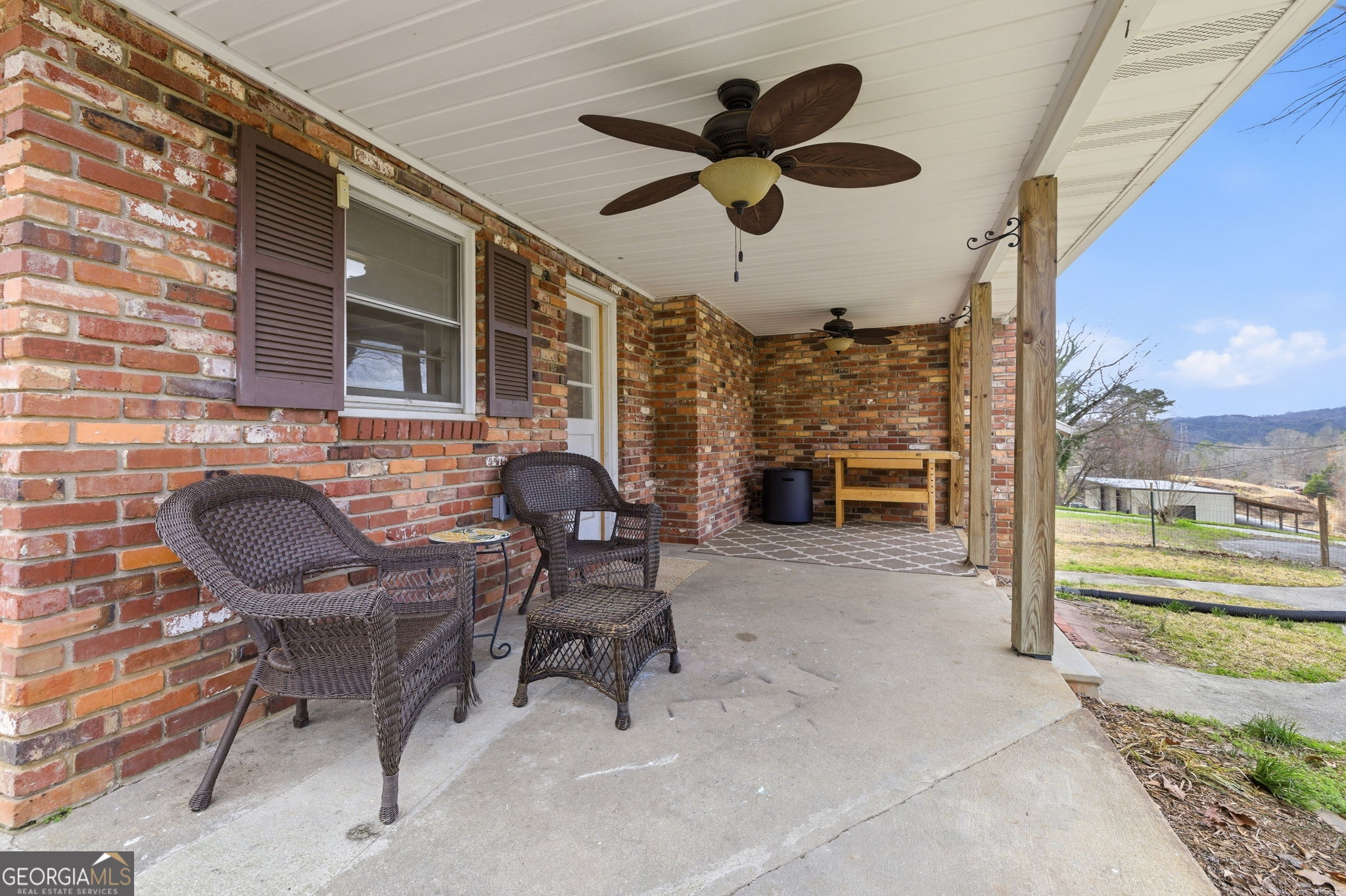 1879 Falls Road Toccoa, GA 30577 - Photo 30 of 36 a balcony with furniture and a floor to ceiling window