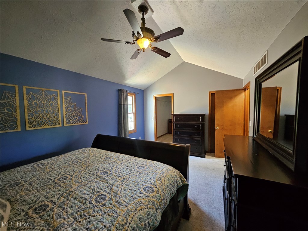 6247 Hathaway Road Cleveland, OH 44125 - Photo 30 of 42 Carpeted bedroom featuring lofted ceiling, a textured ceiling, and a ceiling fan
