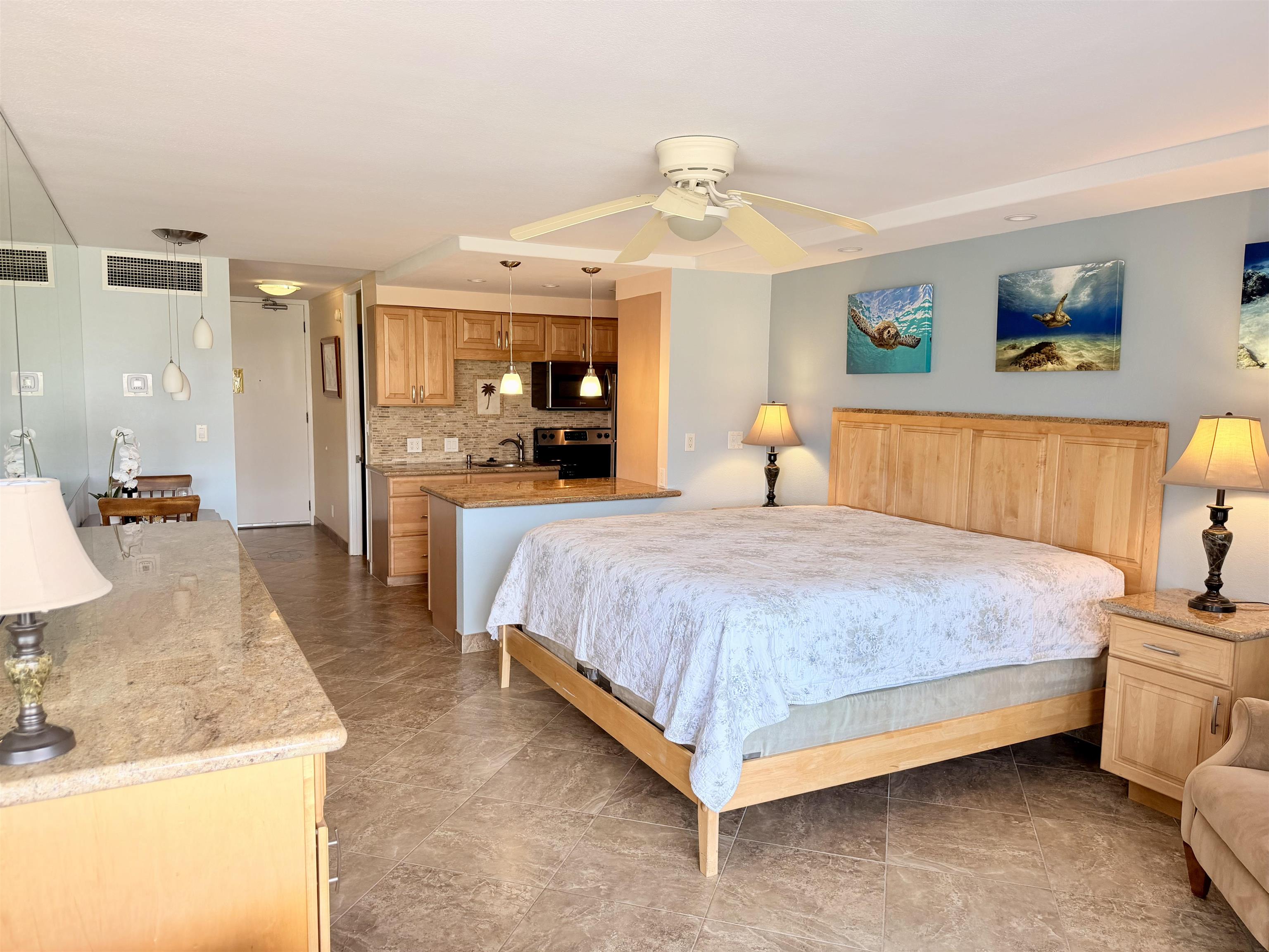 475 Front Street, Unit 320 Lahaina, HI 96761 - Photo 18 of 41 a large bedroom with a bed and wooden floor