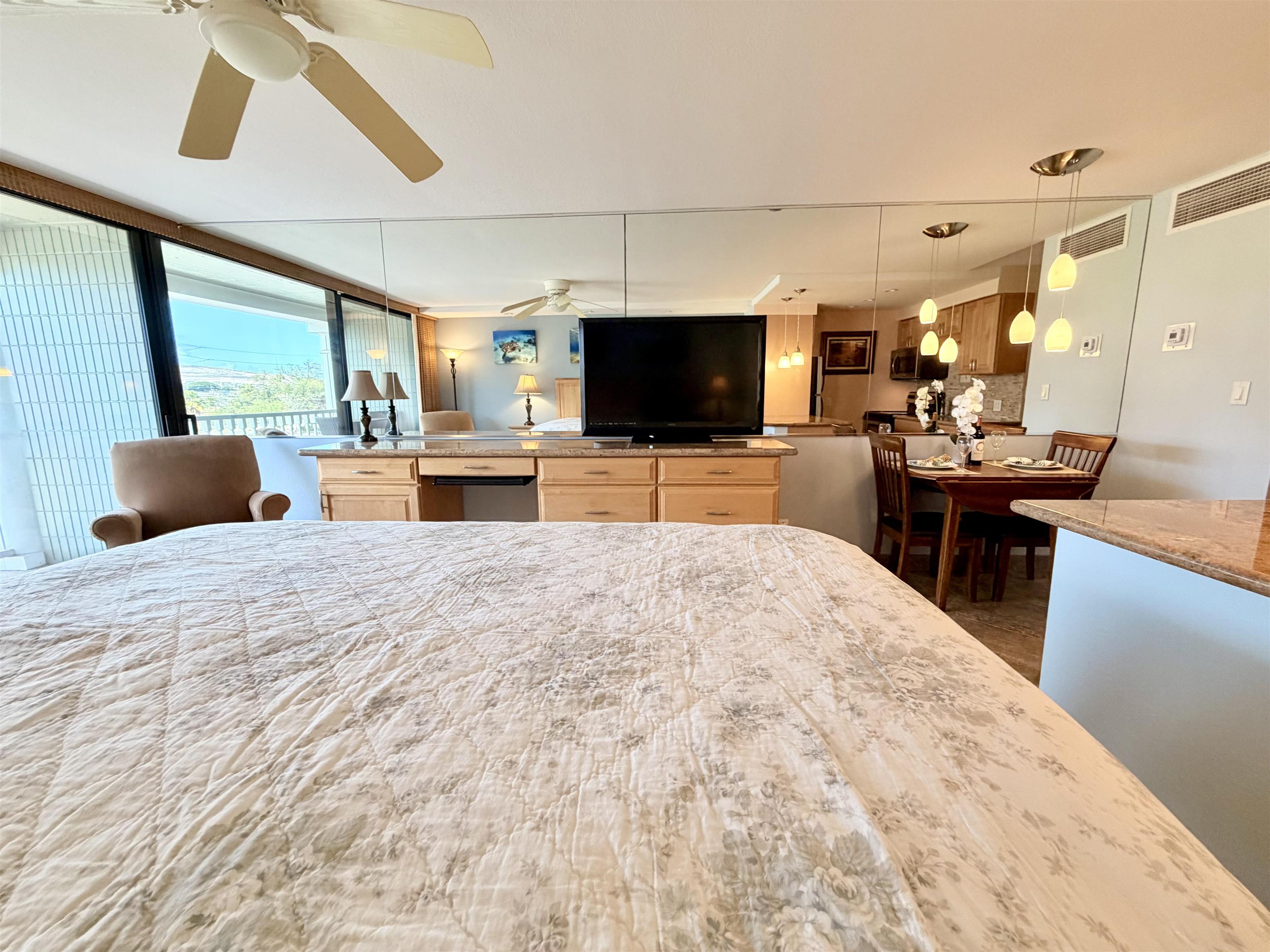 475 Front Street, Unit 320 Lahaina, HI 96761 - Photo 19 of 41 a bedroom with a bed and a flat screen tv