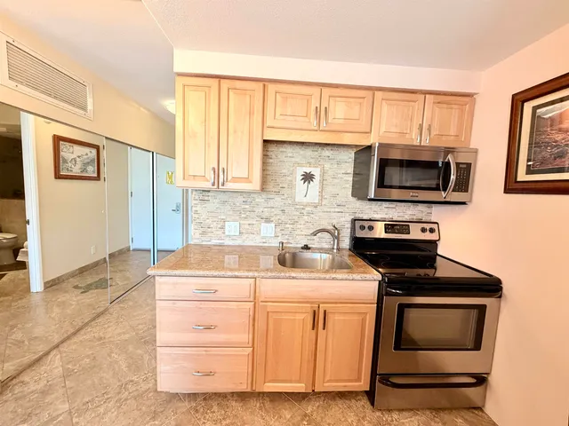 a kitchen with a stove microwave and sink