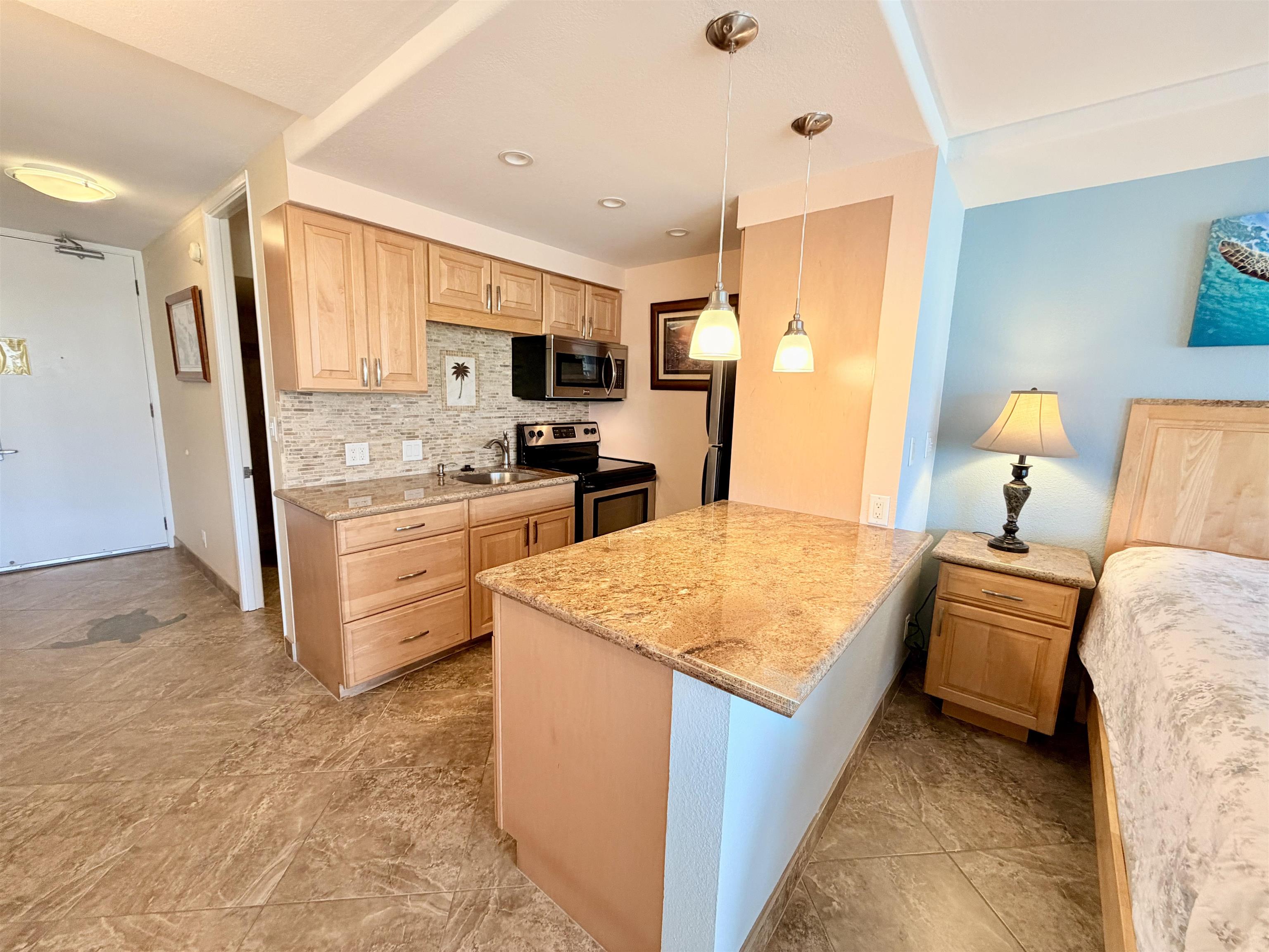 475 Front Street, Unit 320 Lahaina, HI 96761 - Photo 3 of 41 a kitchen with stainless steel appliances granite countertop a sink stove and refrigerator