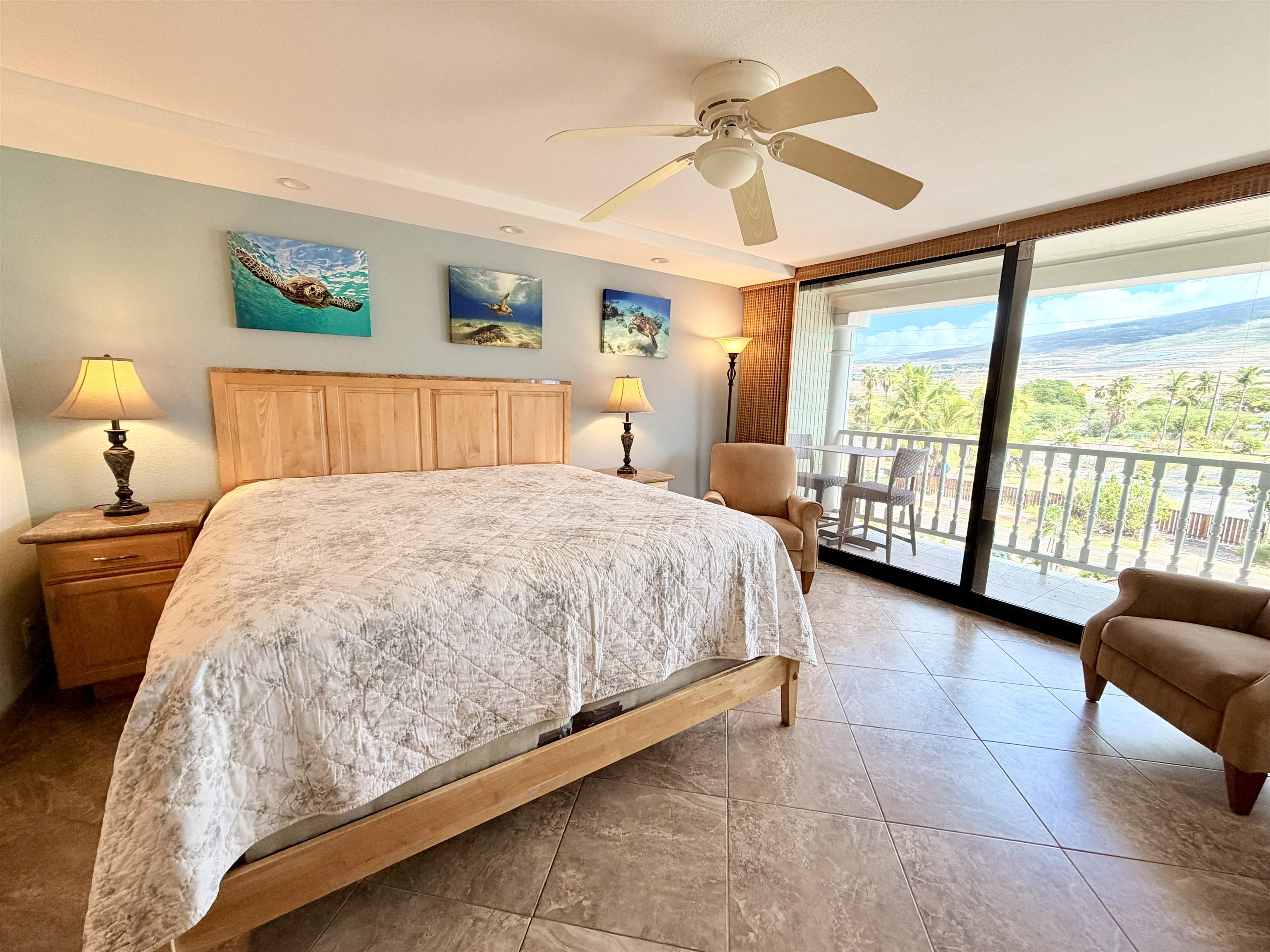 475 Front Street, Unit 320 Lahaina, HI 96761 - Photo 10 of 41 a bedroom with a large bed and a chandelier