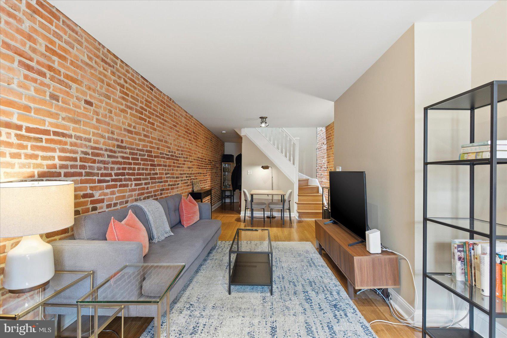 a living room with furniture fireplace and flat screen tv