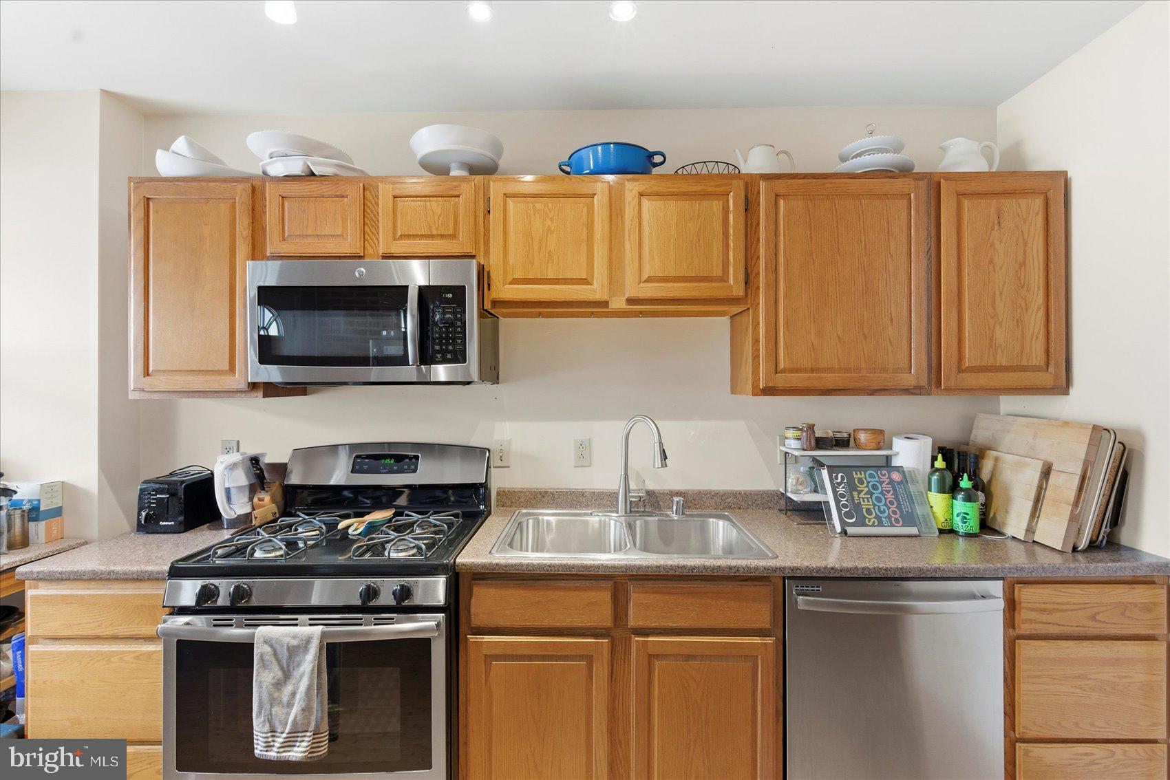 1408 Webster Street Baltimore, MD 21230 - Photo 11 of 30 a kitchen with stainless steel appliances granite countertop a sink a stove a microwave and cabinets