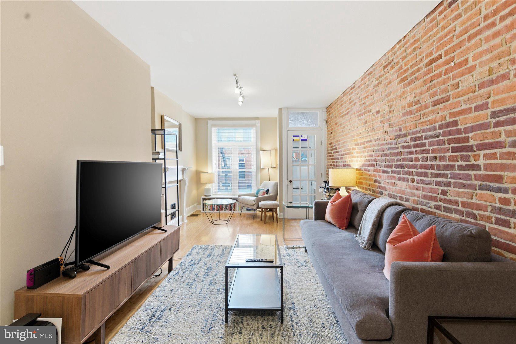 1408 Webster Street Baltimore, MD 21230 - Photo 4 of 30 a living room with furniture and a flat screen tv