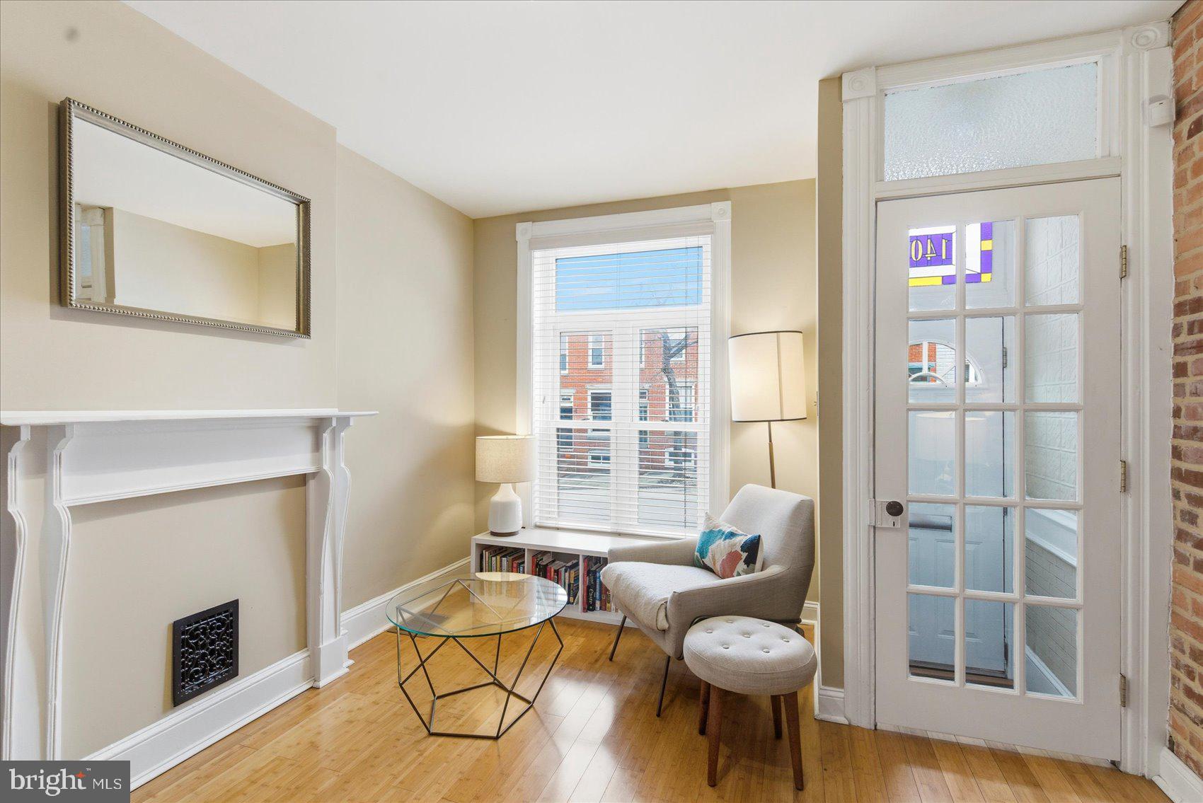 1408 Webster Street Baltimore, MD 21230 - Photo 7 of 30 a living room with furniture a fireplace and a floor to ceiling window