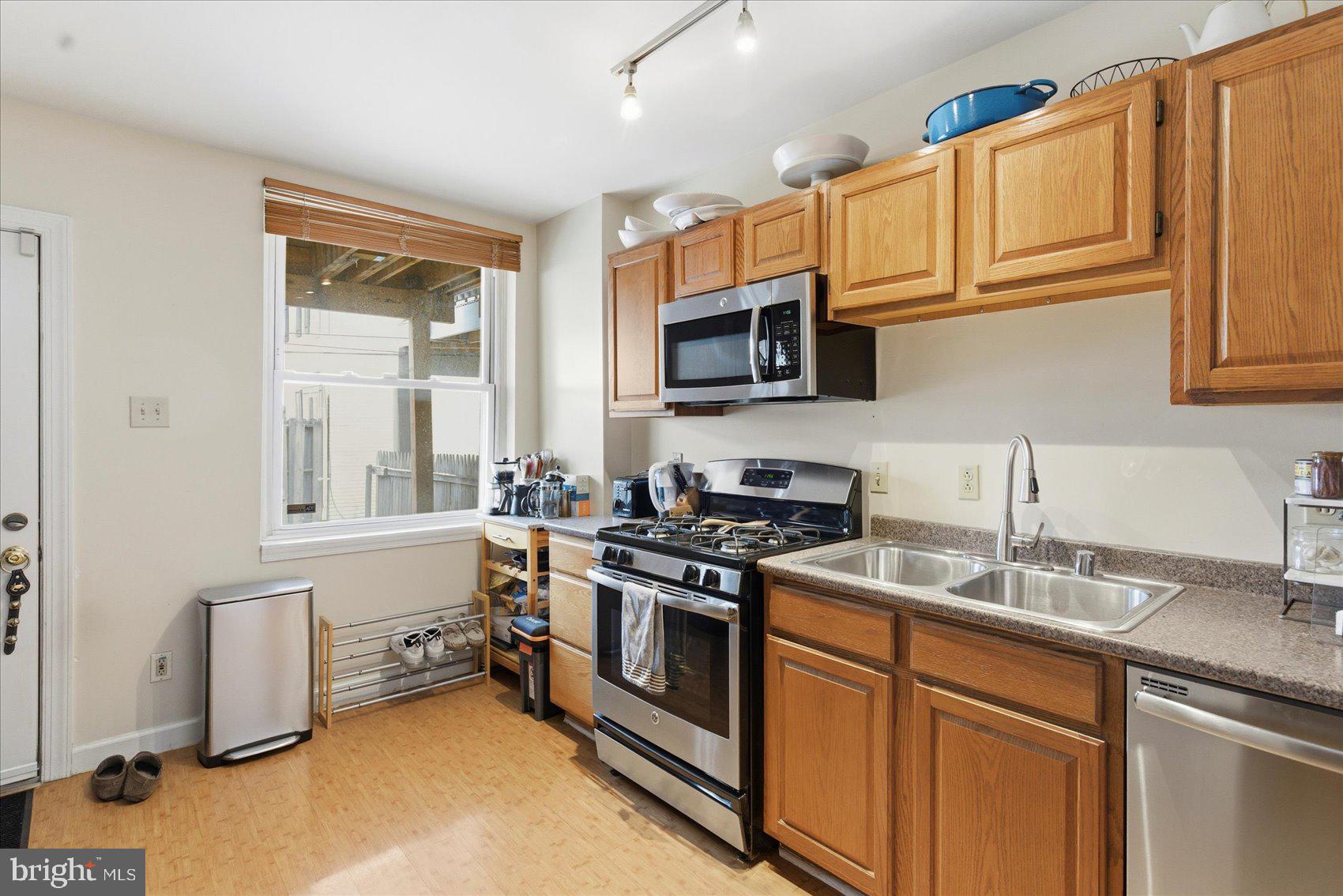 1408 Webster Street Baltimore, MD 21230 - Photo 8 of 30 a kitchen with stainless steel appliances granite countertop a stove a sink and a microwave