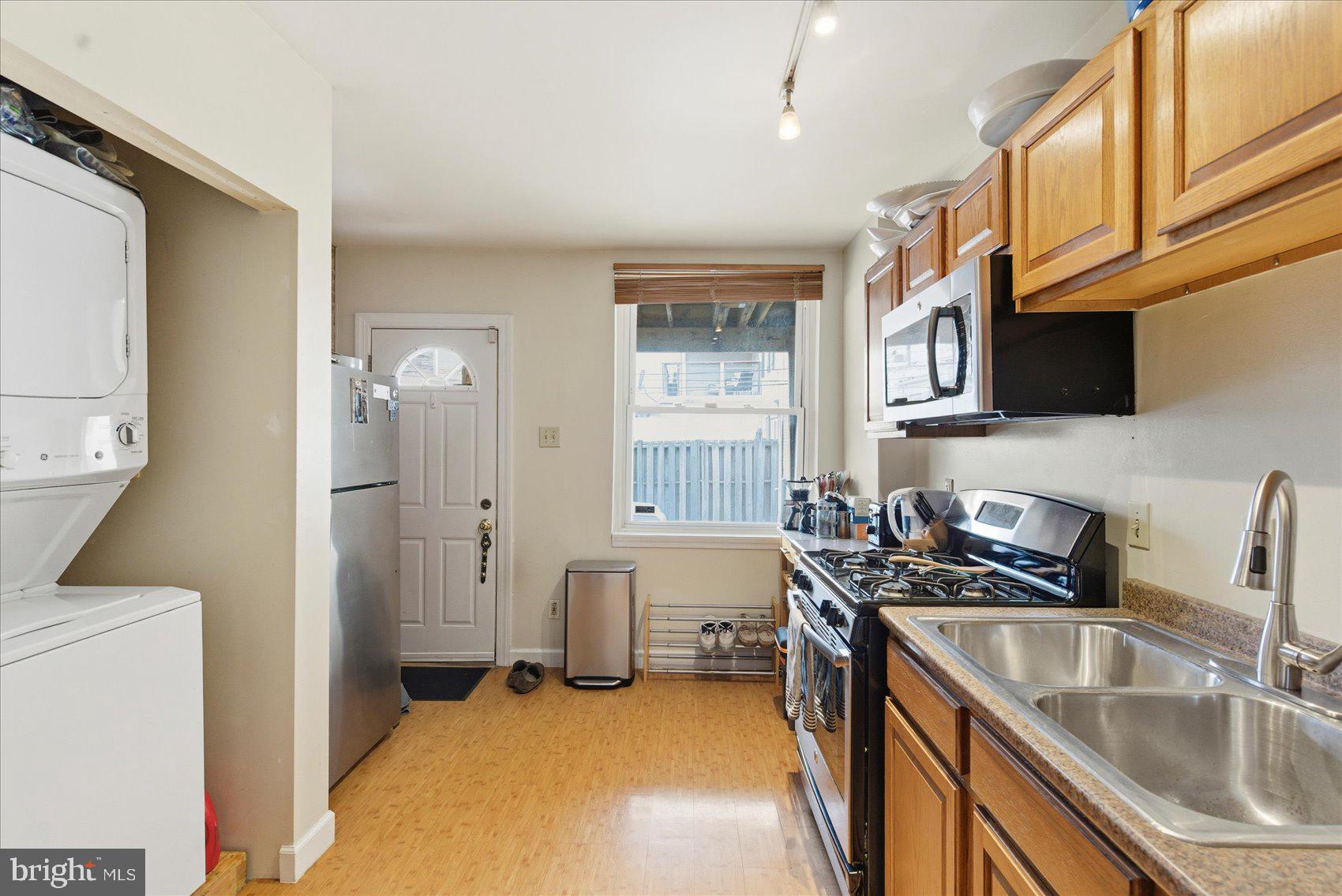 1408 Webster Street Baltimore, MD 21230 - Photo 9 of 30 a kitchen that has a sink a stove and a refrigerator
