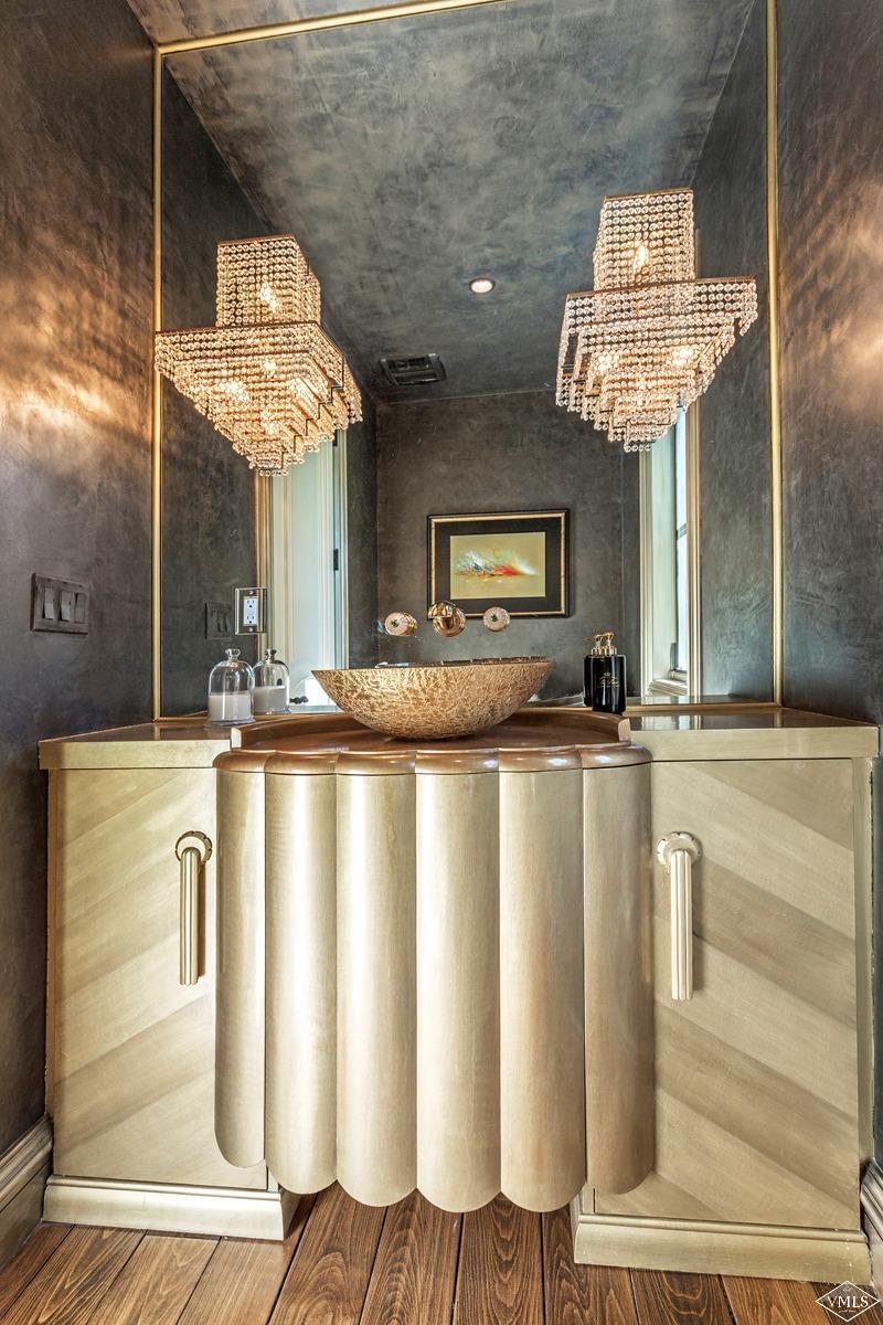 1109 Vail Valley Drive Vail, CO 81657 - Photo 21 of 25 a view of a kitchen with kitchen island stainless steel appliances wooden floor and chandelier