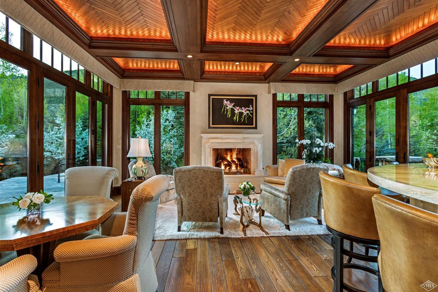 1109 Vail Valley Drive Vail, CO 81657 - Photo 4 of 25 a dining room with furniture a fireplace and wooden floor