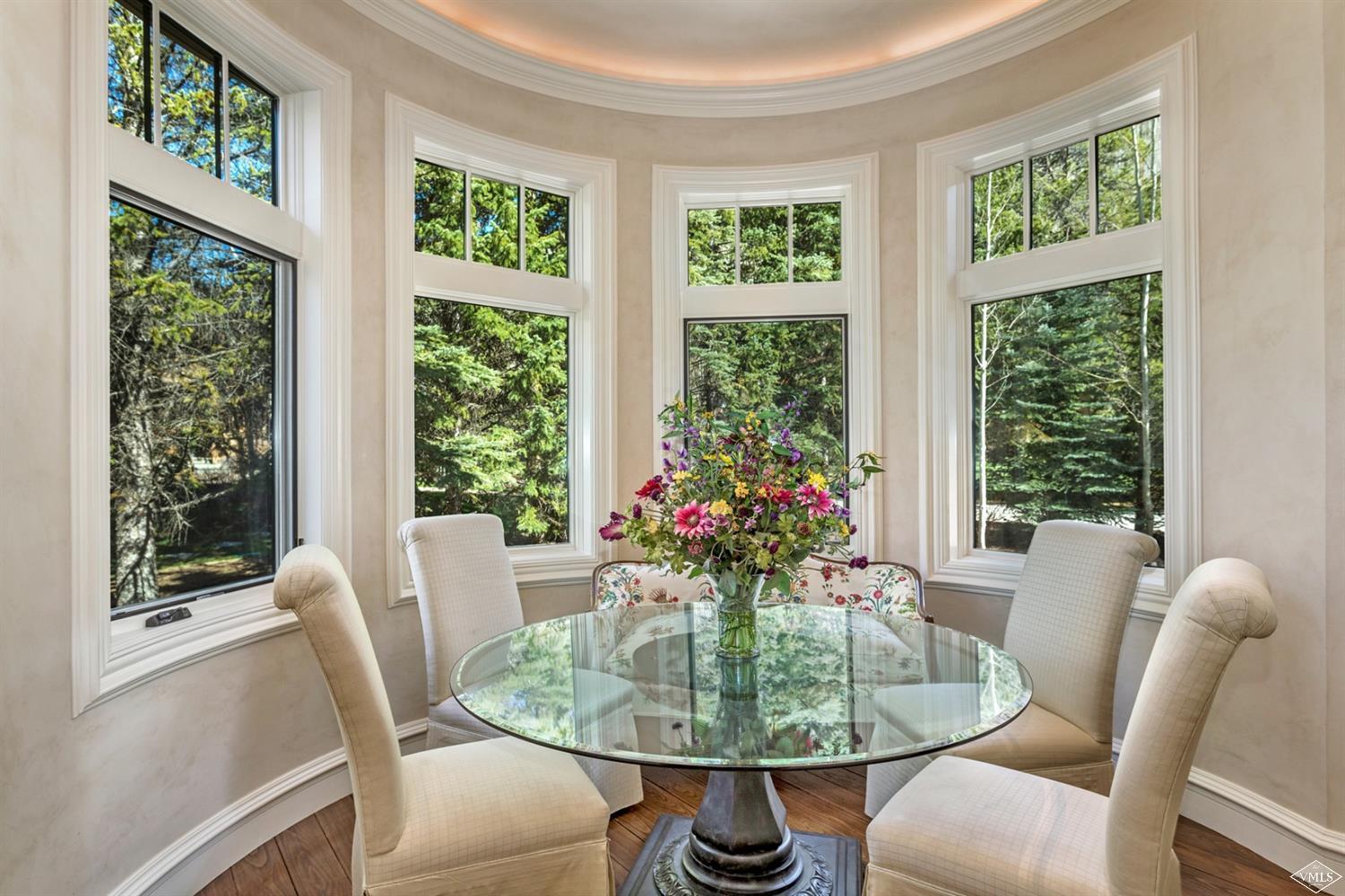 1109 Vail Valley Drive Vail, CO 81657 - Photo 7 of 25 a dining room with furniture window and wooden floor